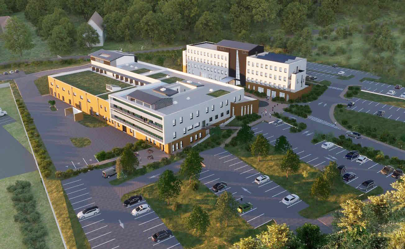 Vue aérienne d'un bâtiment. Il s'agit de la future Clinique du Parc. Les bâtiments sont blancs et gris